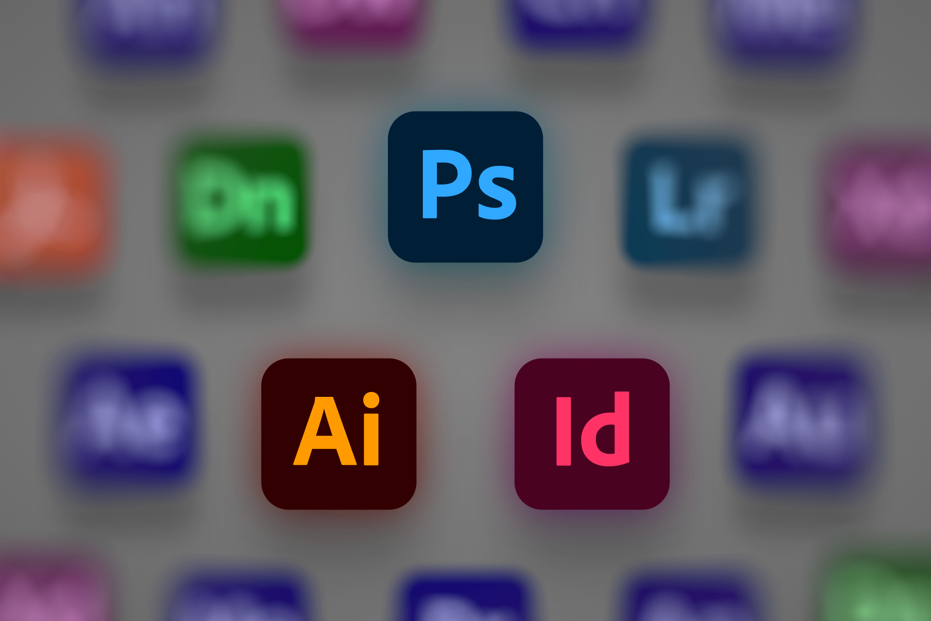 ikony różnych programów pakietu Adobe, z czego wyróżnione są Photoshop, Illustrator i InDesign