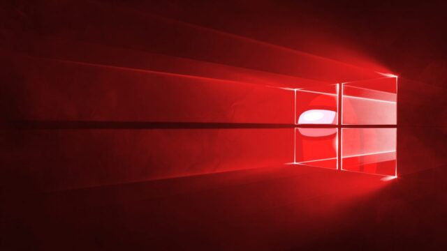 Domyślna tapeta Windows 10 przerobiona na kolor czerwony, a w ikonicznym oknie znajduje się czerwona postać z gry Among Us symbolizująca podejrzenia